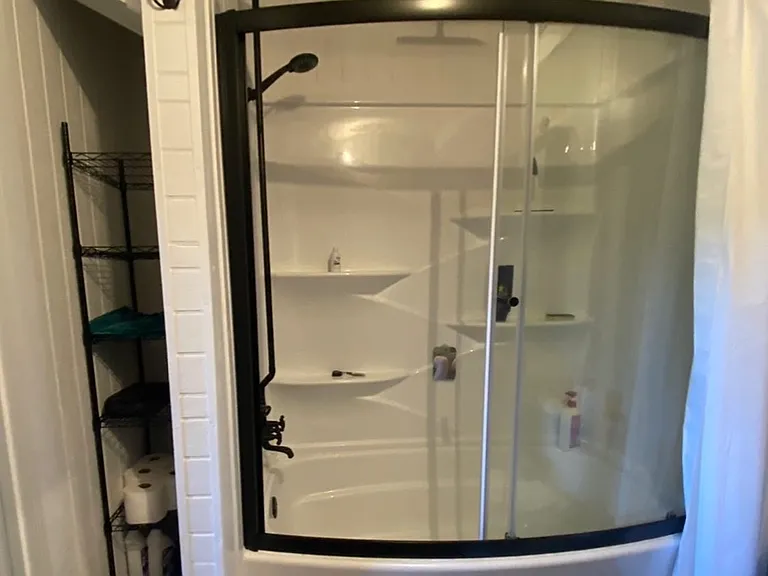 Soaking tub/shower combo. This custom setup allows you to select between a normal showerhead, an overhead rainfall experience, or both. Truly something else. Also: sliding glass doors, ample shelving, and an exhaust fan built to handle the humidity.