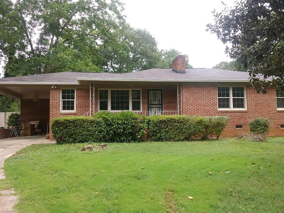 Brick home with off street parking, extra large carport and long driveway