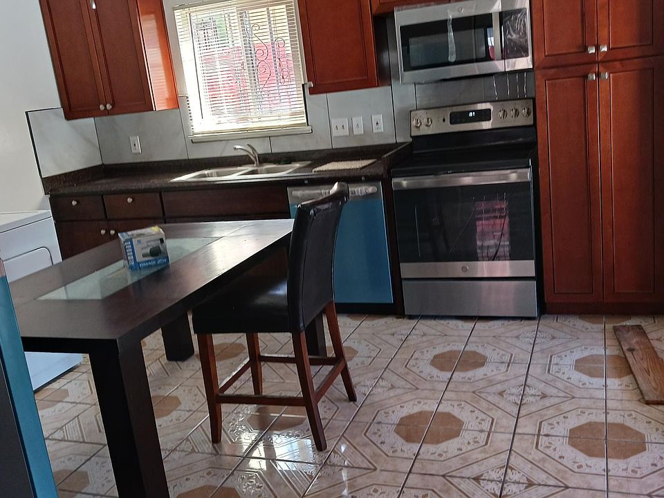 This is the kitchen that includes new stainless steal appliances, new cabinets, and tile flooring.