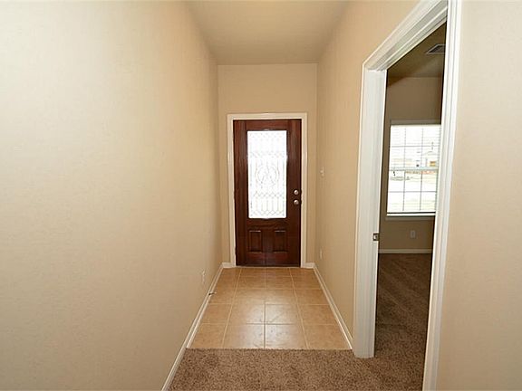 LOOKING AT ENTRYWAY AND FIRST BEDROOM