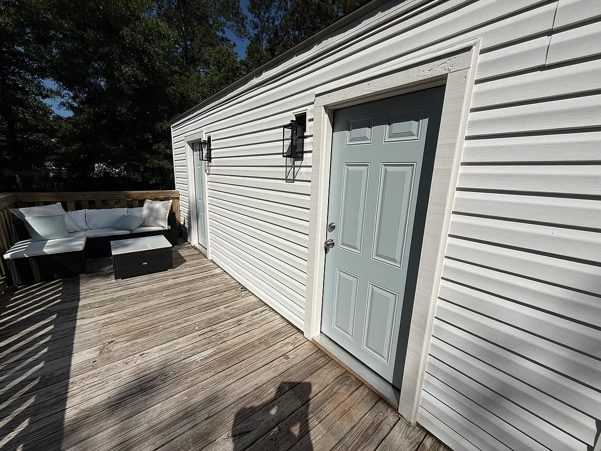 outdoor porch with outdoor sectional included for tenant use - first door opens into main living/kitchen area, second door opens into the 2nd (smaller) bedroom - 80 Palmetto Ave