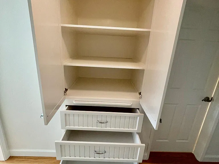 Hallway with generous built-in storage cabinets and drawers