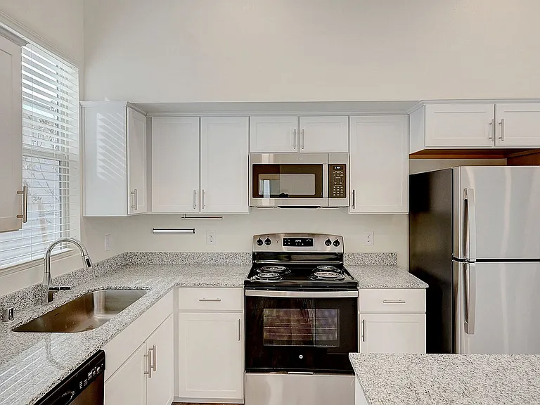 Experience the elegance of this sleek modern kitchen, perfect for culinary enthusiasts.
