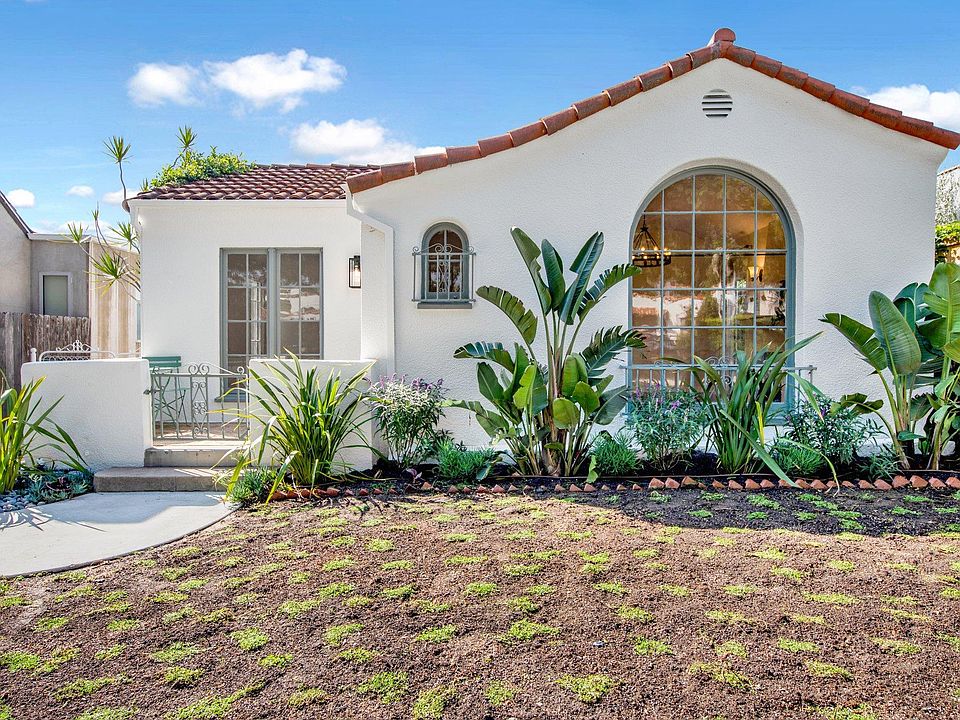 Front of 1920s Spanish home, newly planted ground cover and landscaping. Sprinkler system throughout. Newly painted interior and exterior.