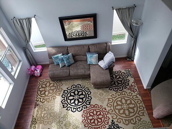 High vaulted ceiling view from 2nd story looking into living room.