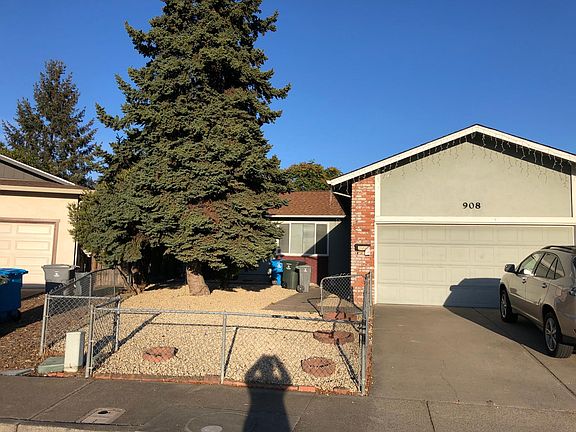 Clean, low-maintenance front yard with mature tree for evening shade.