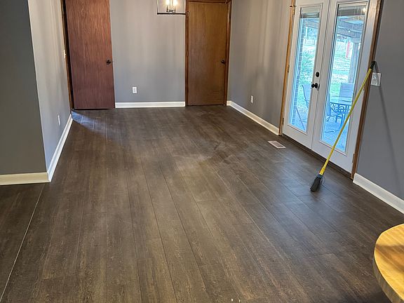 Dining area from the kitchen area, and back door. Entrance to laundry on right and sunroom on the left.