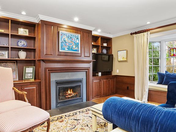 library with fireplace and outdoor entrance