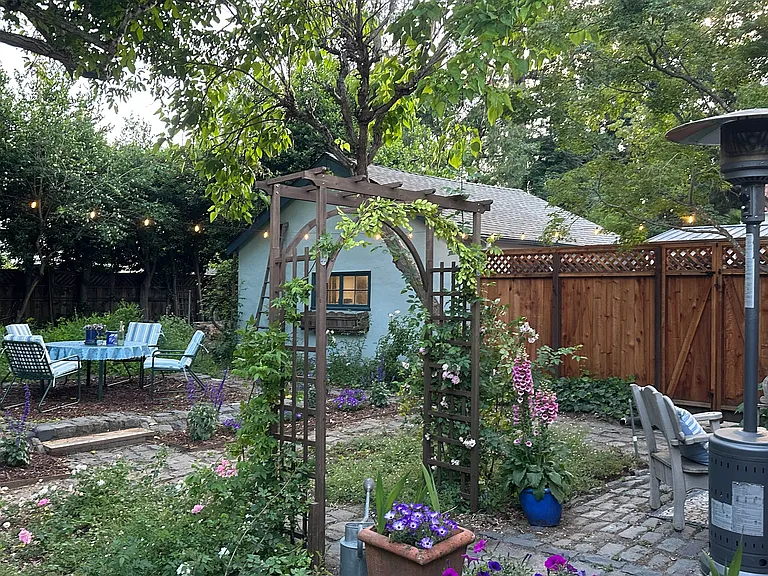 Cobblestone paths, climbing roses, and mature trees, make for perfect place for entertaining or relaxing.