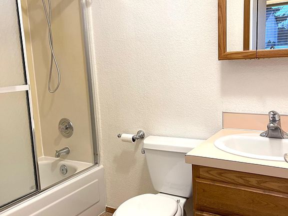 This is the original bathroom. It now has a tile tub surround, new cabinet, new floors and new mirror.
