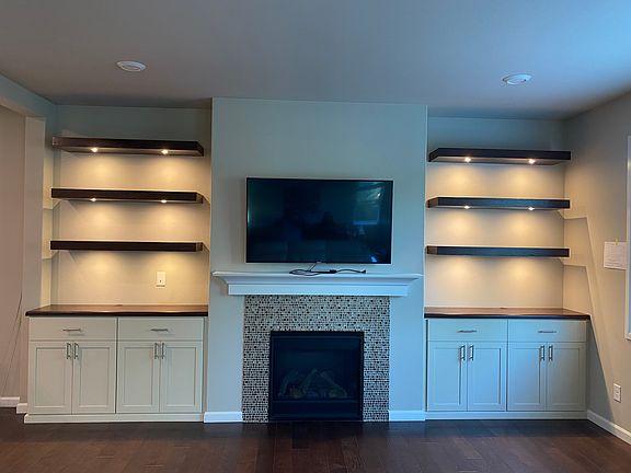 Custom cabinets with floating shelves and lights
