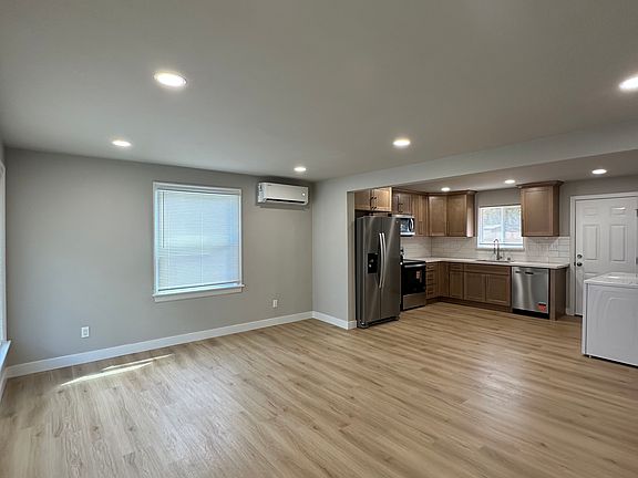 Large living room connects to kitchen. Open concept layout.