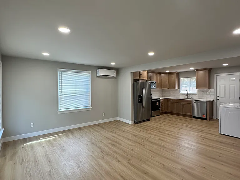 Large living room connects to kitchen. Open concept layout.
