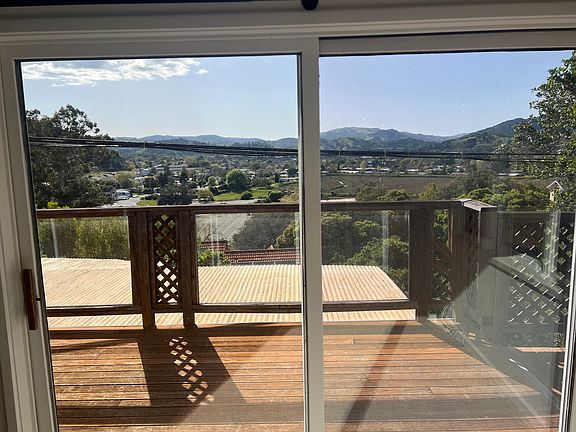 View from living room onto private deck and mountains