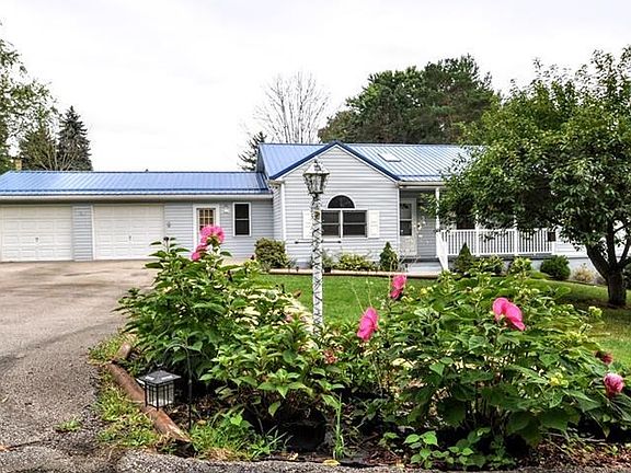 You won't tire of the lush greenery surrounding your home or the easy, one-level living, level driveway, and large 2-car garage.