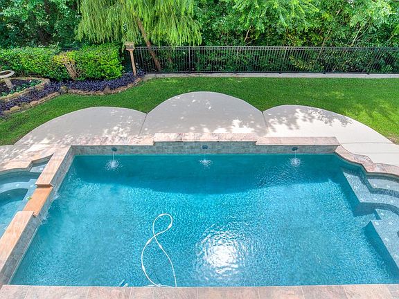 The beautiful pool which includes a hot tub. The deck was recently patched and repainted - with the appropriate paint.