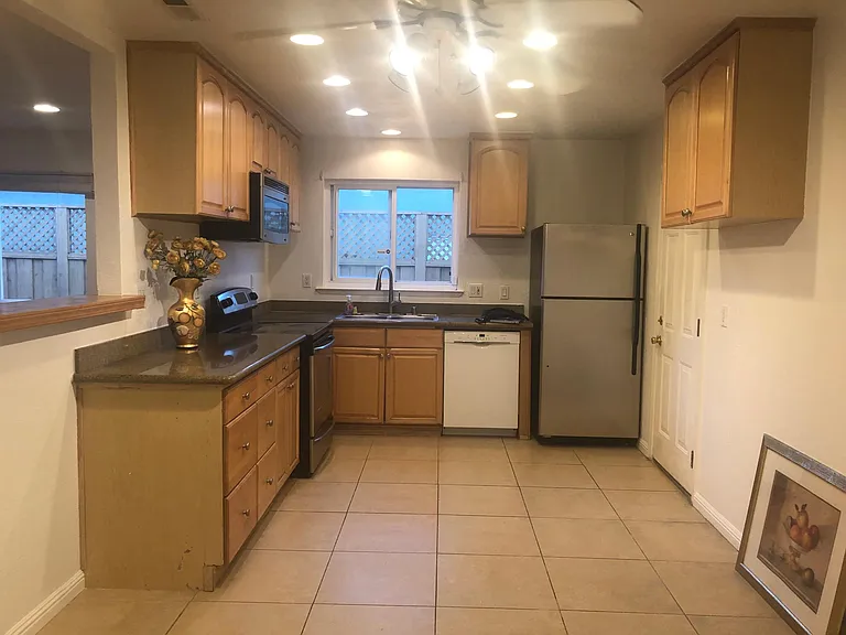 Open and modern kitchen/dining area combo with a new Bosch low noise dishwasher + new refrigerator + new over-the-range microwave with vent oven. Dining sitting area has more built in lights and ceiling fan