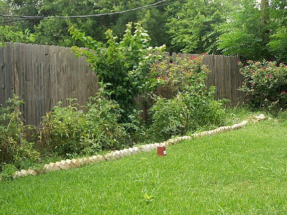 Extensive flower beds. Some have vegetables growing