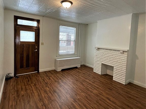 Living room: 14 x 13. With decorative fireplace.
