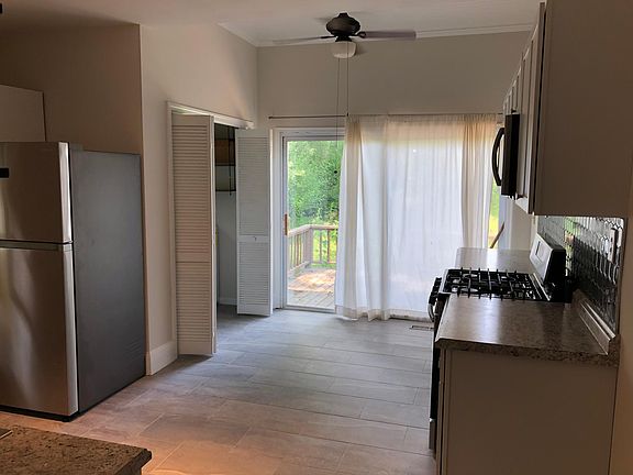 Updated kitchen with new stainless appliances and sliding doors to the back deck