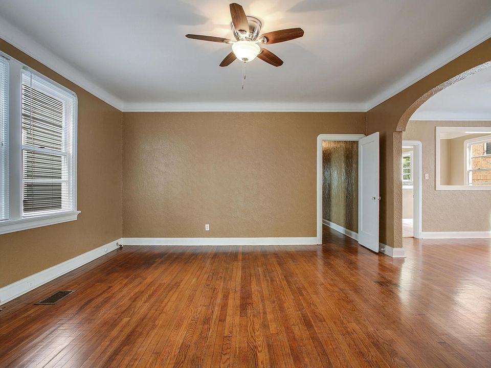 Large open living room, and adjacent open dining room, throu
