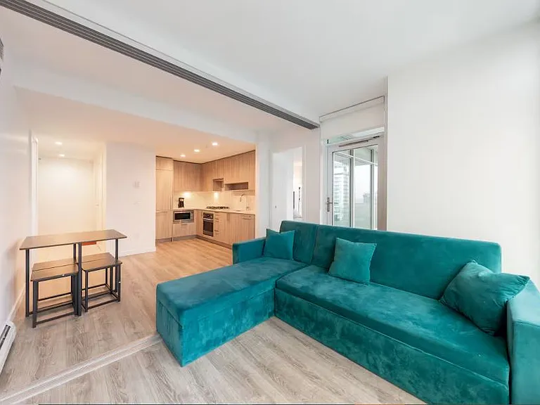 Cozy living space featuring a large, comfortable couch perfect for relaxing, with a flat-screen TV for entertainment.