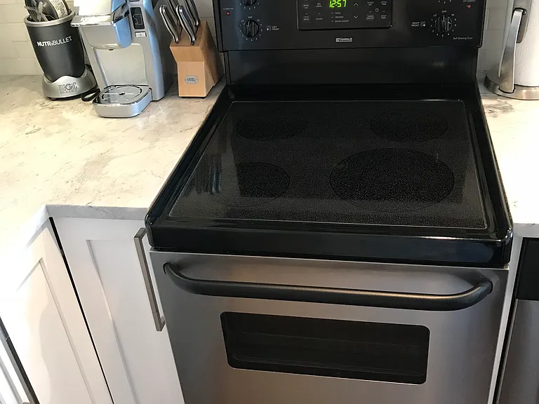 Pullout spice cabinets next to stove.