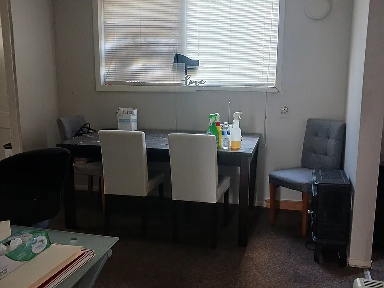 Dining room with table and chairs for potential tenant in need.