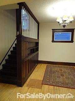 Entry Room 2
						:
						Beautiful oak bookshelf, trimwork, and chandelier give guests a warm welcome.