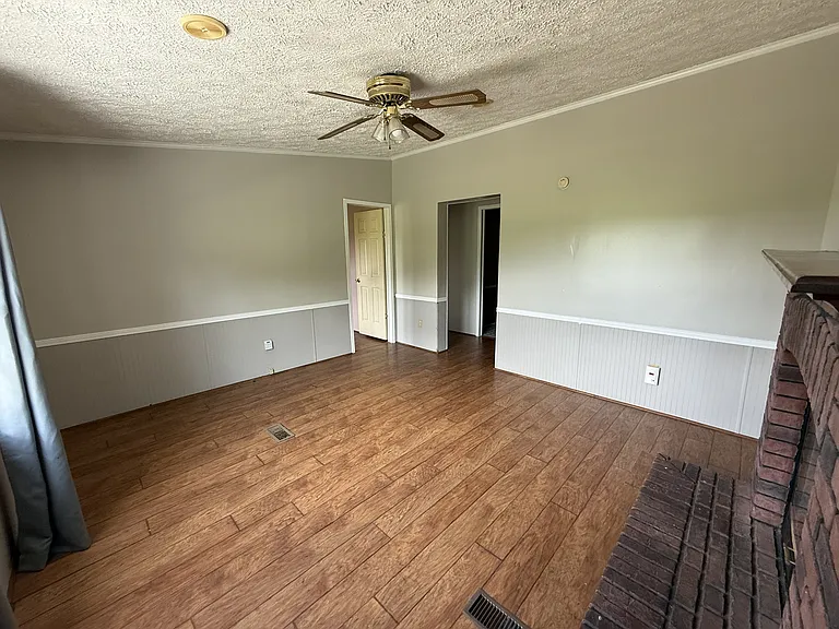 Den with view of bedrooms and bonus room