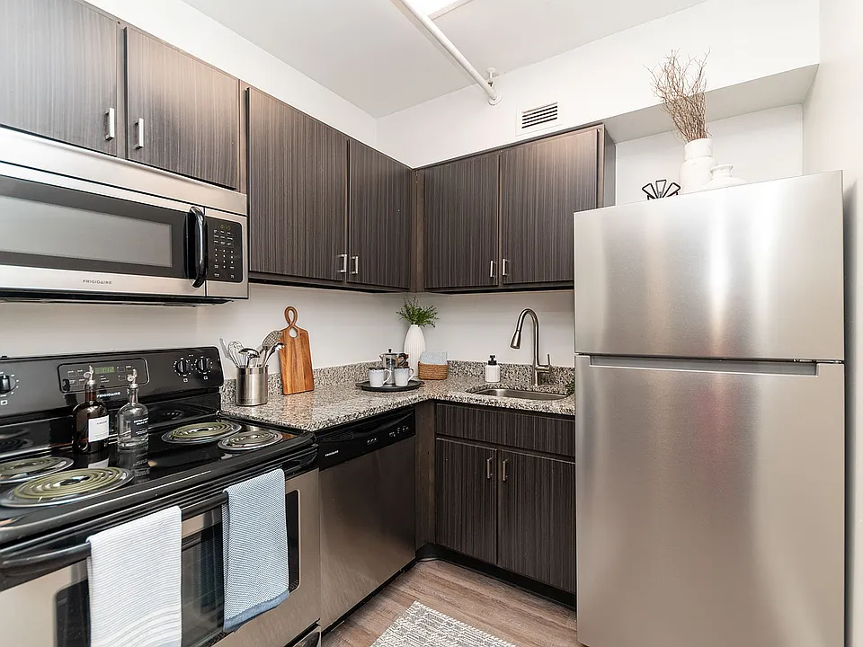 Kitchen with granite counters, modern cabinetry, and stainless appliances