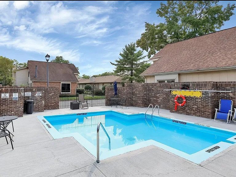 Community gated pool a few doors down behind condo