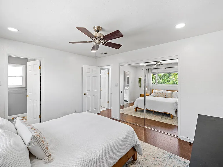 Master bedroom with windows overlooking the backyard
