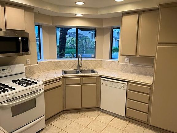 Lots of kitchen cabinets and counter top.