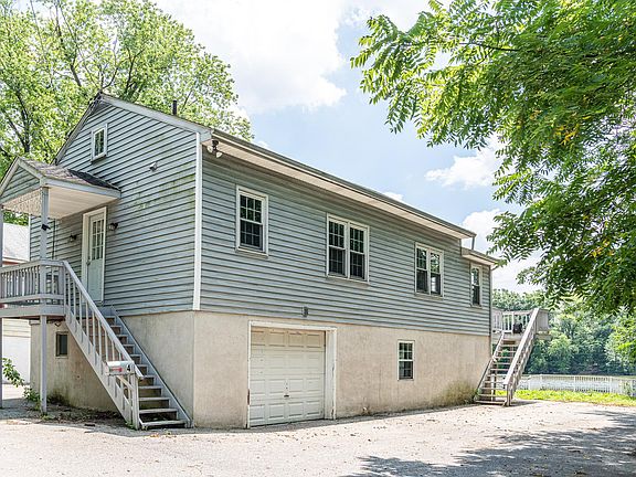 The staircase to the left leads to the kitchen. The staircase to the right leads to the deck and front door. The garage and ground floor are not available to the tenant. Parking is on the right side.