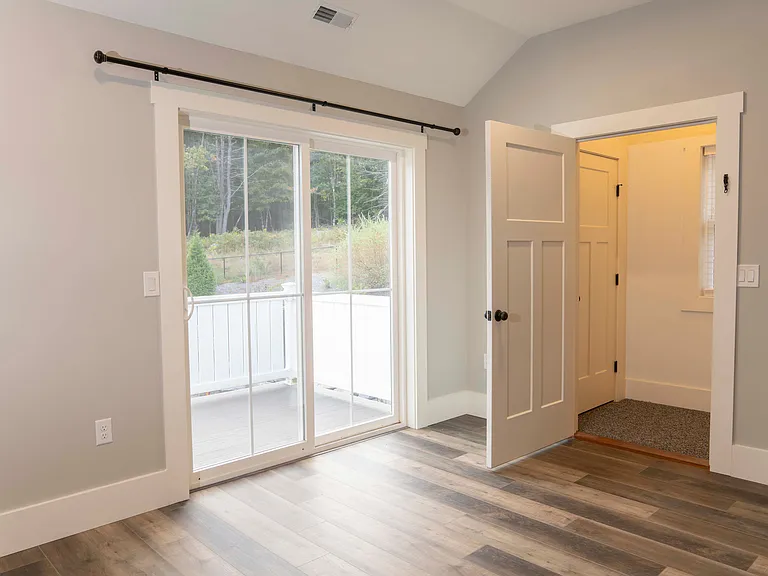 Living room, slider to 15'x8' deck, door to entrance/stairway. The entrance includes a spacious closet.