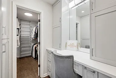 Primary bedroom has private vanity area with custom cabintry, built in makeup, drawers, electrical builts in for hairdryers and other personal care appliances. Oodles of storage for a home this size.