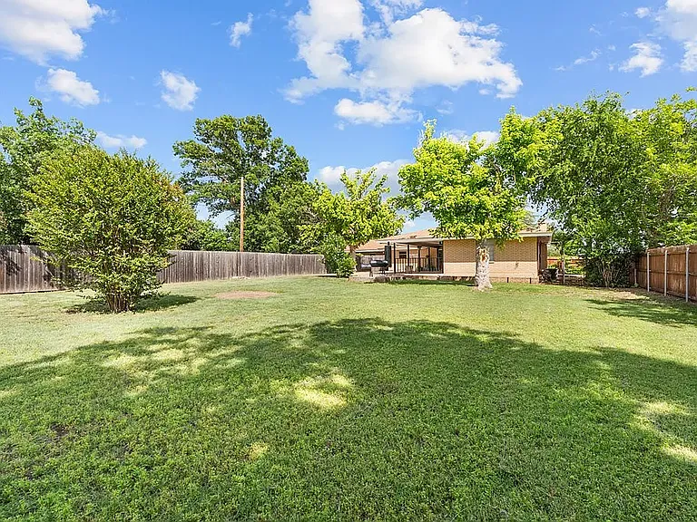 View of back of home and privacy fence between the 2 duplexes (view from the back of the large yard)
