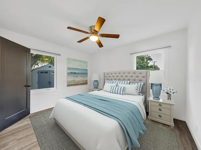 Primary bedroom with private yard views & blackout blinds.