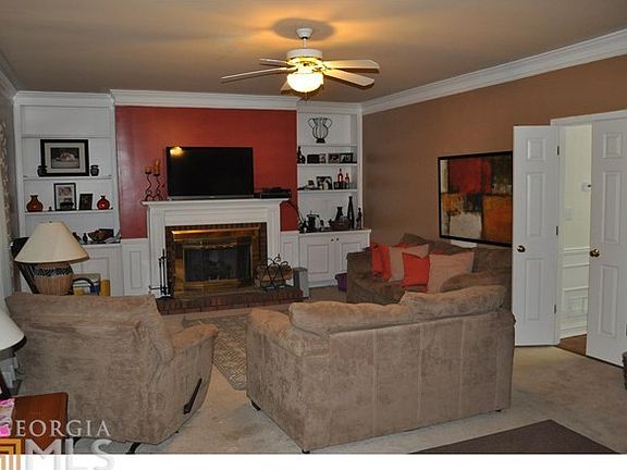 FAMILY ROOM WITH FIREPLACE VIEWS TO KITCHEN AND DOBLE DECK