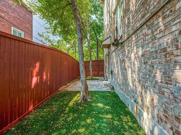 Backyard with turf and decorative lighting