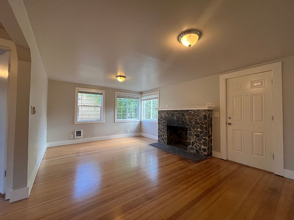 Gleaming newly refinished fir floors and brand new paint throughout, with a functioning wood-burning fireplace.