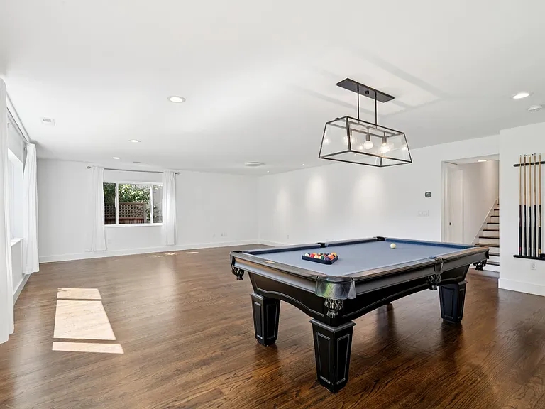 Family room with pool table! This room opens to the yard.