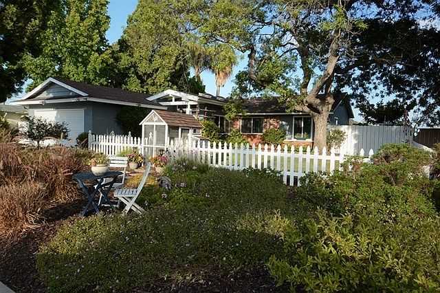 Like an illustration from a Grimm's Fairy Tale... complete with Pickett Fence, Mature flowering Shade Trees and Romantic Gardens.  Total Privacy and Panoramic Views...