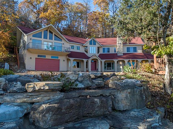 Two levels of living space featuring 6,225 sq ft, 5 beds, 5 full baths, 2 half baths, and 2 full sized kitchens.