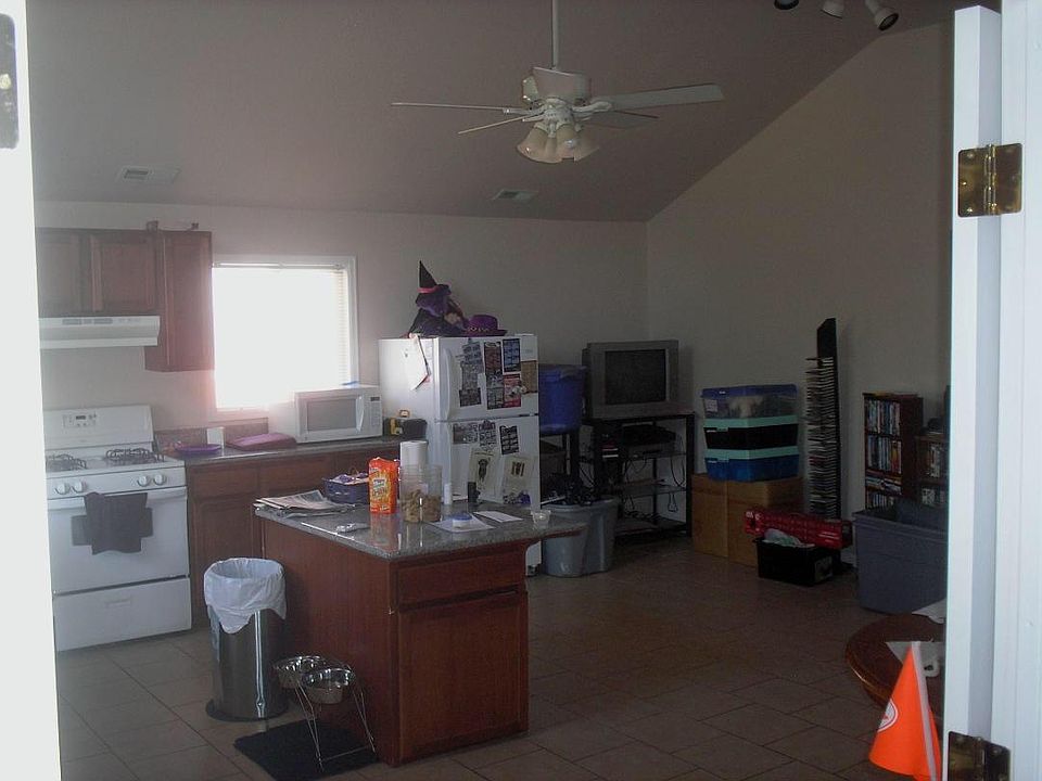Kitchen and family room with vaulted ceiling, office area, island, ceiling fan