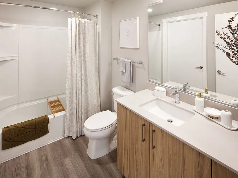 Design Collection II Bath with oak cabinetry, white quartz countertop, and hard surface flooring