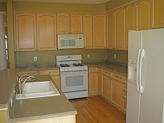 Kitchen w/Corian counters & island overlooks Family room