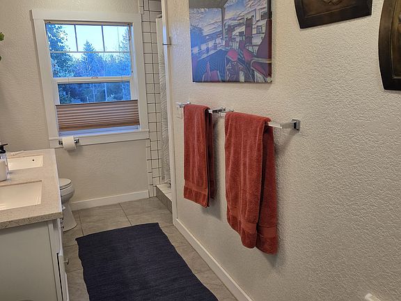 Double sink, double shower bathroom. Heated floors. Linen storage with walk in closet