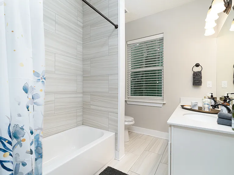 Refresh in style. This clean and modern space comes fully prepared for your arrival, offering a generous vanity area and bright, welcoming lighting